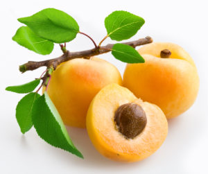 Apricots with leaves on a white background.